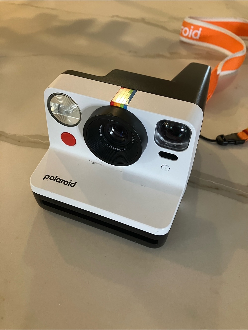 working Polaroid White Instant Camera with Rainbow Accent and Orange Strap